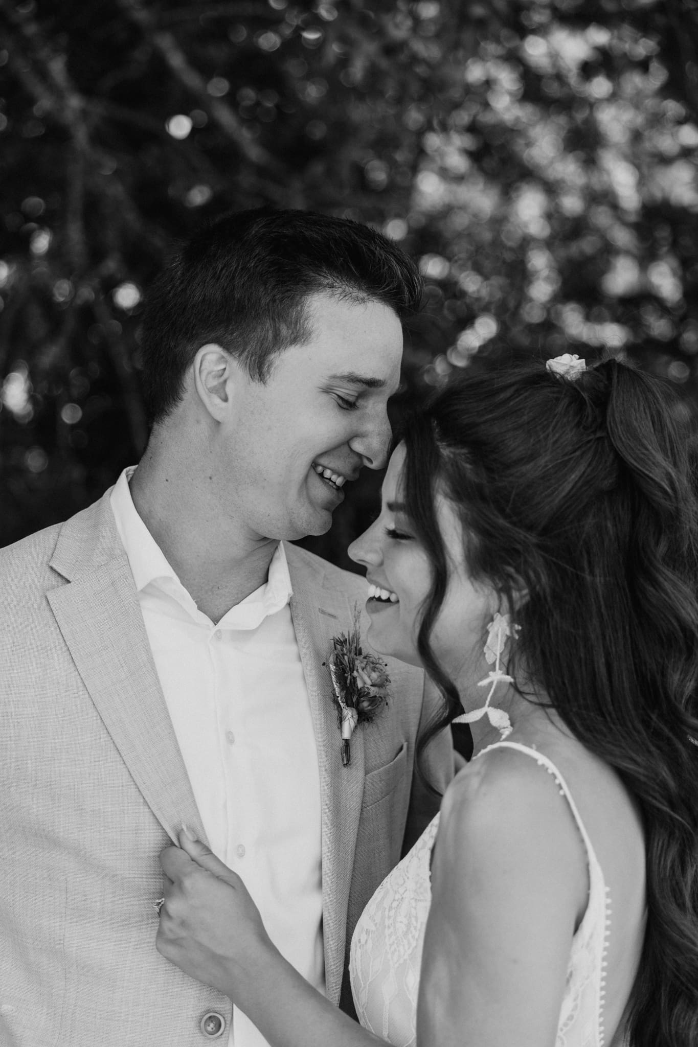Candid moment of newlyweds laughing together during their Michigan wedding day.