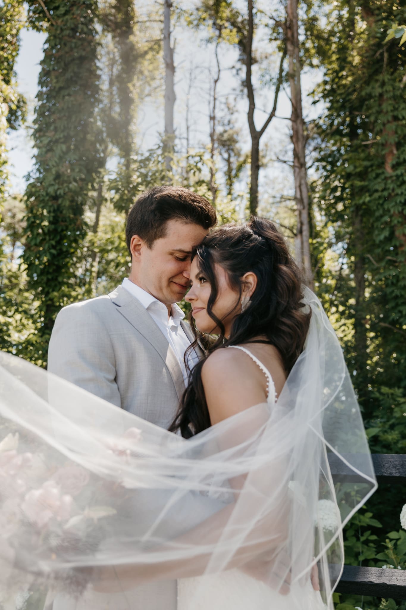 Bride and groom looking into the distance during their outdoor Michigan wedding.